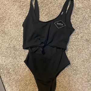 Black one piece with open front.
